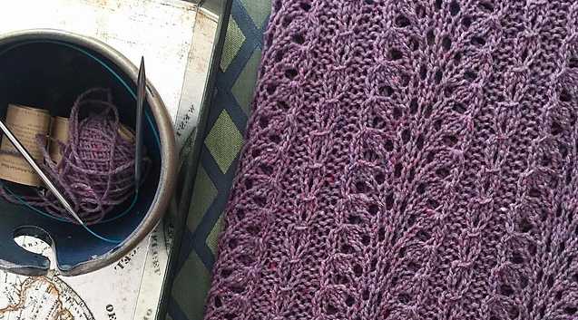 A piece of my own knitting, a detailed purple lace baby blanket.