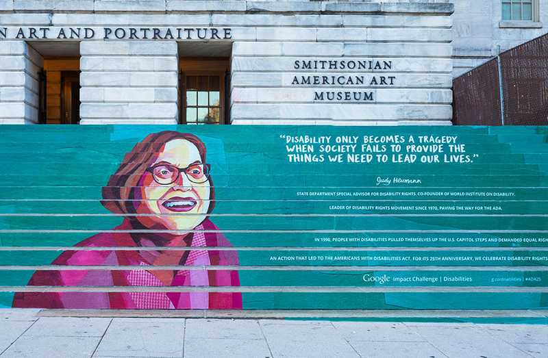 The steps of the National Portrait Gallery in Washington, DC painted with a mural of Judy Heumann, with her quote, "Disabilty only becomes a tragedy when society fails to provide the things we need to lead our lives."